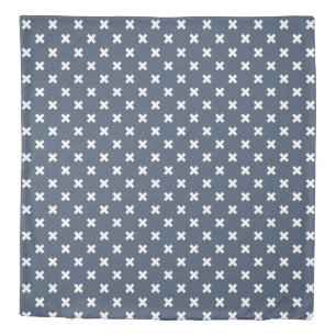 White cross stitches on blue-grey duvet cover
