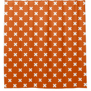 White cross stitches on burnt orange shower curtain