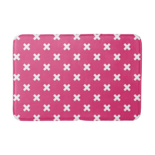 White cross stitches on fuchsia bath mat
