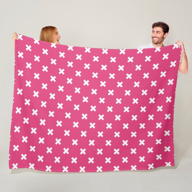 White cross stitches on fuchsia fleece blanket (In Situ)