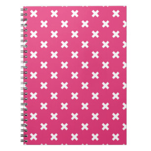 White cross stitches on fuchsia notebook