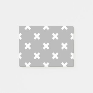 White cross stitches on gray post-it notes