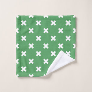 White cross stitches on green wash cloth