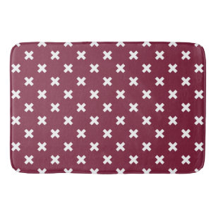 White cross stitches on mulberry bath mat