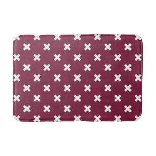 White cross stitches on mulberry bath mat
