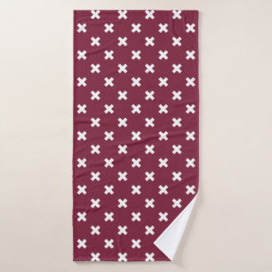 White cross stitches on mulberry bath towel