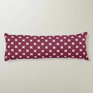 White cross stitches on mulberry body pillow