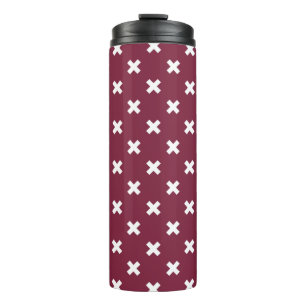 White cross stitches on mulberry thermal tumbler