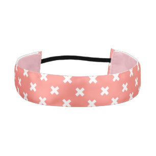 White cross stitches on peach athletic headband
