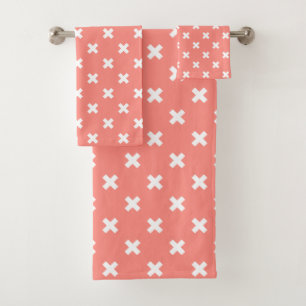 White cross stitches on peach bath towel set