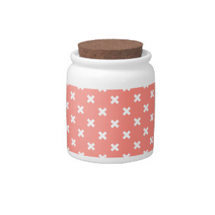 White cross stitches on peach candy jar