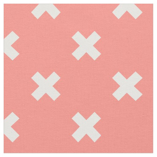 White cross stitches on peach fabric