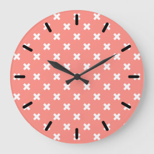 White cross stitches on peach large clock