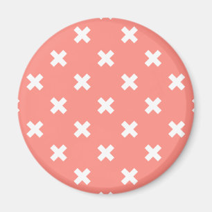 White cross stitches on peach magnet