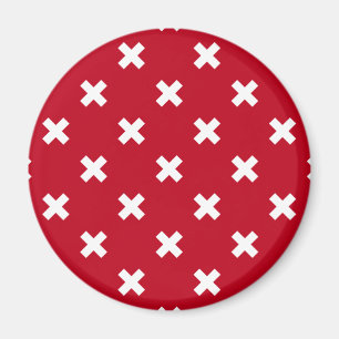 White cross stitches on red magnet