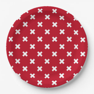 White cross stitches on red paper plates