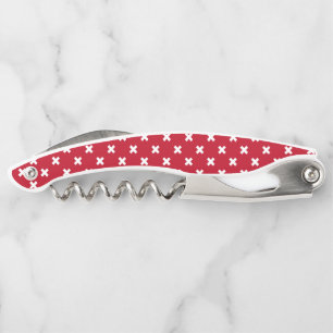 White cross stitches on red waiter's corkscrew