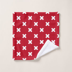 White cross stitches on red wash cloth