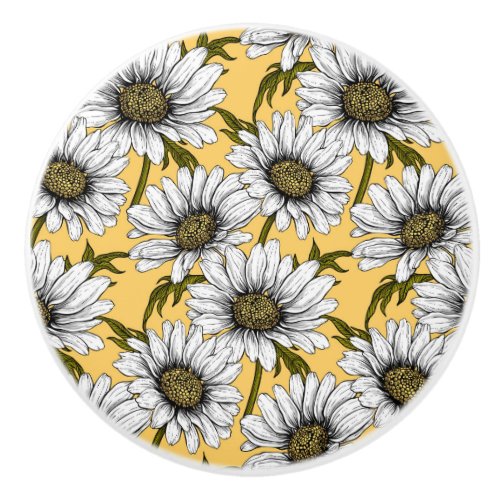 White daisies wild flowers on yellow ceramic knob