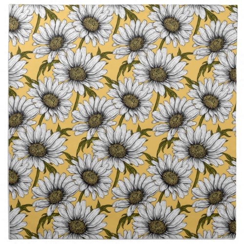 White daisies wild flowers on yellow cloth napkin