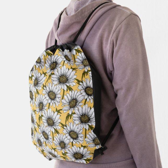White daisies, wild flowers on yellow drawstring bag (Insitu)