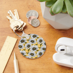 White daisies, wild flowers on yellow keychain