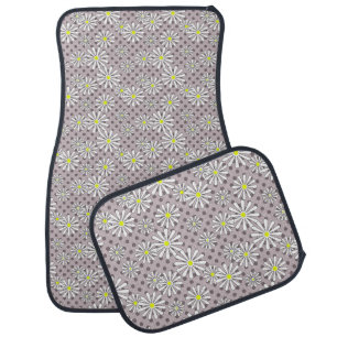 White daisy flowers on a beige brown polka dot car floor mat
