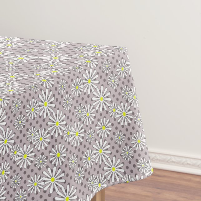 White daisy flowers on a beige brown polka dot tablecloth (In Situ)