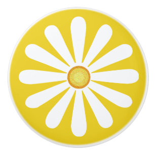 White daisy with yellow in centre on golden yellow ceramic knob