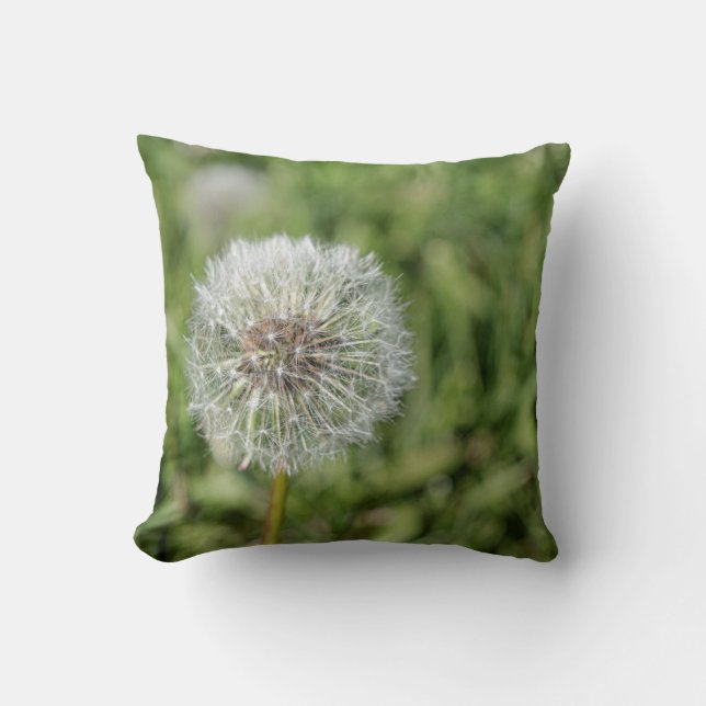 White dandelion flower on green grass throw pillow (Front)