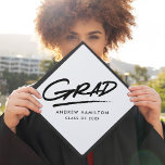 White | Dashed Grad Graduation Cap Topper<br><div class="desc">Personalized graduation cap topper featuring "Grad" in black hand-lettering with a dashed underline with a white background or color of your choice. Personalize the custom graduation cap topper by adding the graduate's name and graduation year.</div>