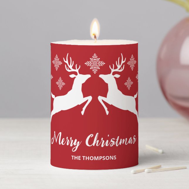 White Deer Shapes On Red With Snowflakes & Text Pillar Candle (In Situ)