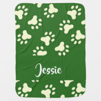 White dog paws on green baby blanket