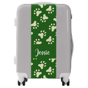 White dog paws on green luggage