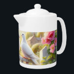White Doves Cottage Garden Teapot<br><div class="desc">Two white doves rest together on a weathered garden gate, framed by blooming roses and soft spring foliage beneath a warm, glowing sky. The scene evokes gentle romance, peace, and timeless countryside charm, blending cottagecore nostalgia with a dreamy watercolor aesthetic. Pastel pinks, creamy whites, and sunlit greens create an airy,...</div>