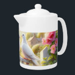 White Doves Cottage Garden Teapot<br><div class="desc">Two white doves rest together on a weathered garden gate, framed by blooming roses and soft spring foliage beneath a warm, glowing sky. The scene evokes gentle romance, peace, and timeless countryside charm, blending cottagecore nostalgia with a dreamy watercolor aesthetic. Pastel pinks, creamy whites, and sunlit greens create an airy,...</div>