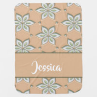 White engraved flowers on tan baby blanket