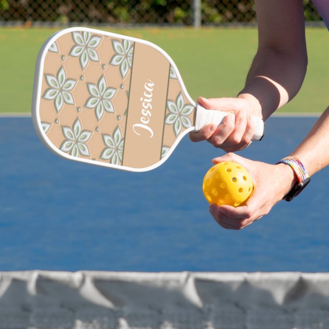 White engraved flowers on tan pickleball paddle (Insitu)