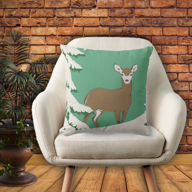 White Faced Brown Deer in snow by Pine Tree Outdoor Pillow (Brown white faced female deer in snow by pine tree on mint green home decor pillow.)