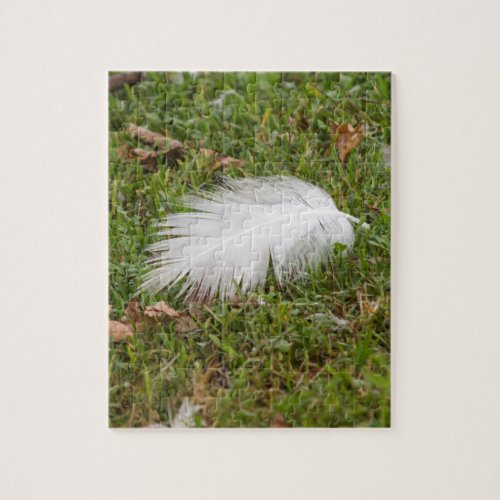 white feather on meadow jigsaw puzzle