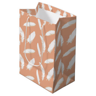 White feather print on soft peach medium gift bag