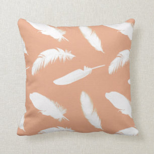 White feather print on soft peach throw pillow