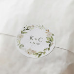 White Floral Greenery Wedding Classic Round Sticker<br><div class="desc">Elevate your wedding stationery with our White Floral and Greenery Wedding Envelope or Favor Sticker. This exquisite sticker showcases a delicate arrangement of white florals and lush greenery, adding a touch of elegance and natural beauty to your invitations, envelopes, or favor packaging. Designed with meticulous attention to detail, the sticker...</div>