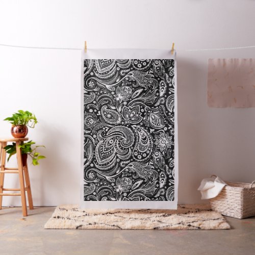 White floral paisley pattern on black fabric