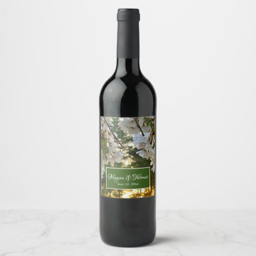 White flowering tree buds sunrise thru pine trees  wine label