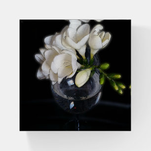 white freesia in a glass paperweight