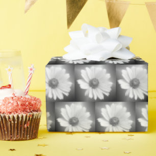 white glowing daisy on black wrapping paper
