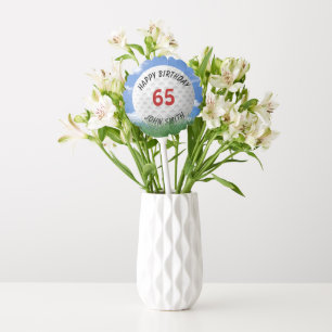 white golf ball in grass for birthday balloon