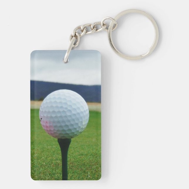 white Golf Ball on a mountain golf course Keychain (Back)