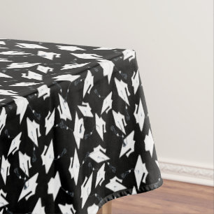 White Graduation Caps Tossed in the Air on Black Tablecloth